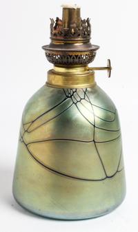 An Iridescent Glass Fluid Lamp Height of lamp base 8 inches. — SIGNED ILLEGIBLY, DATED 1892