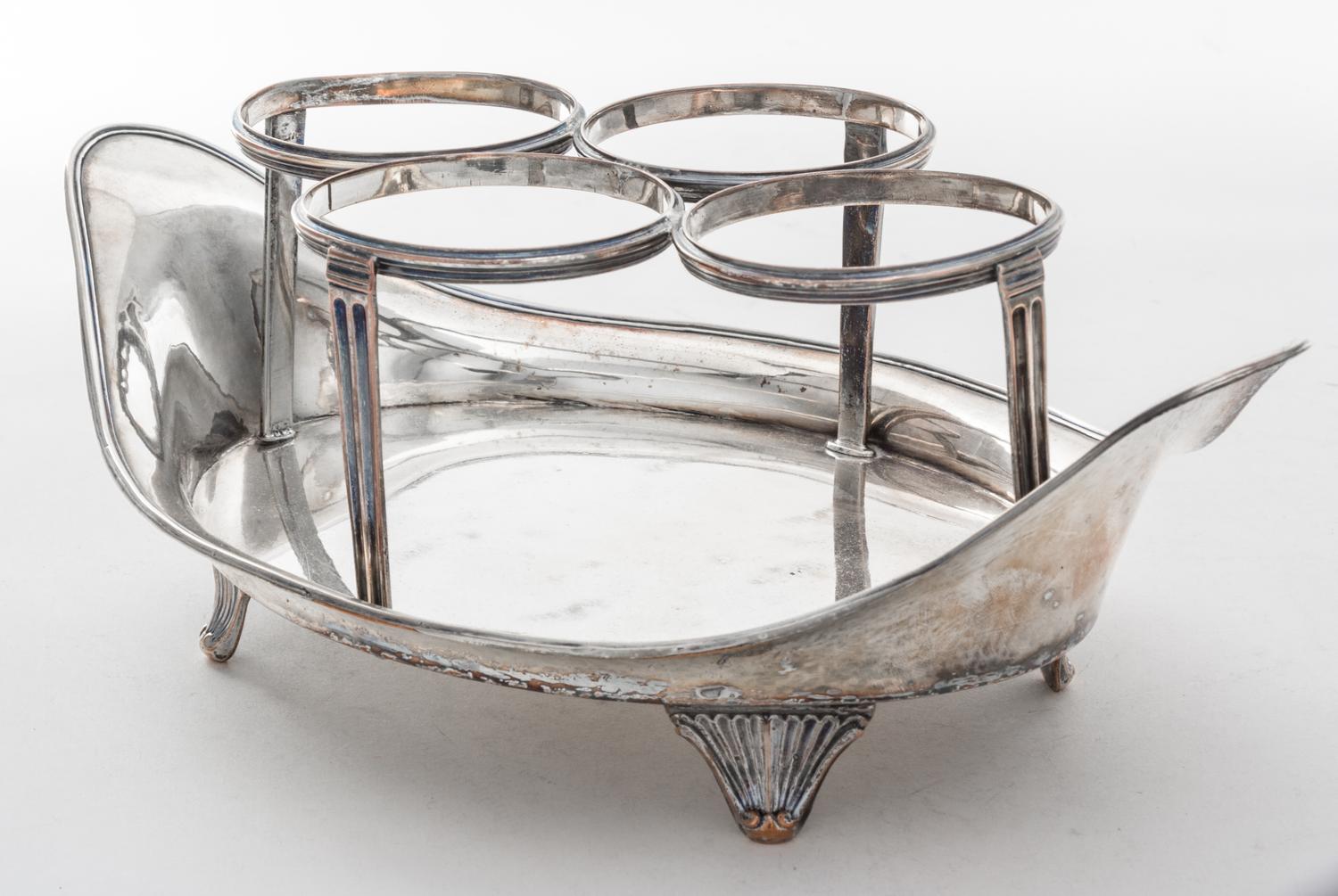 A Sheffield-plate Cruet Set, Early 19th Century, of oval boat form with reeded rims and raised on conforming bracket supports, fitted f
