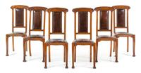 An Italian Art Nouveau Style Walnut Dining Suite Height of table 31 1/2 x width 47 1/2 (closed) x depth 40 1/4 inches. — 20TH CENTURY