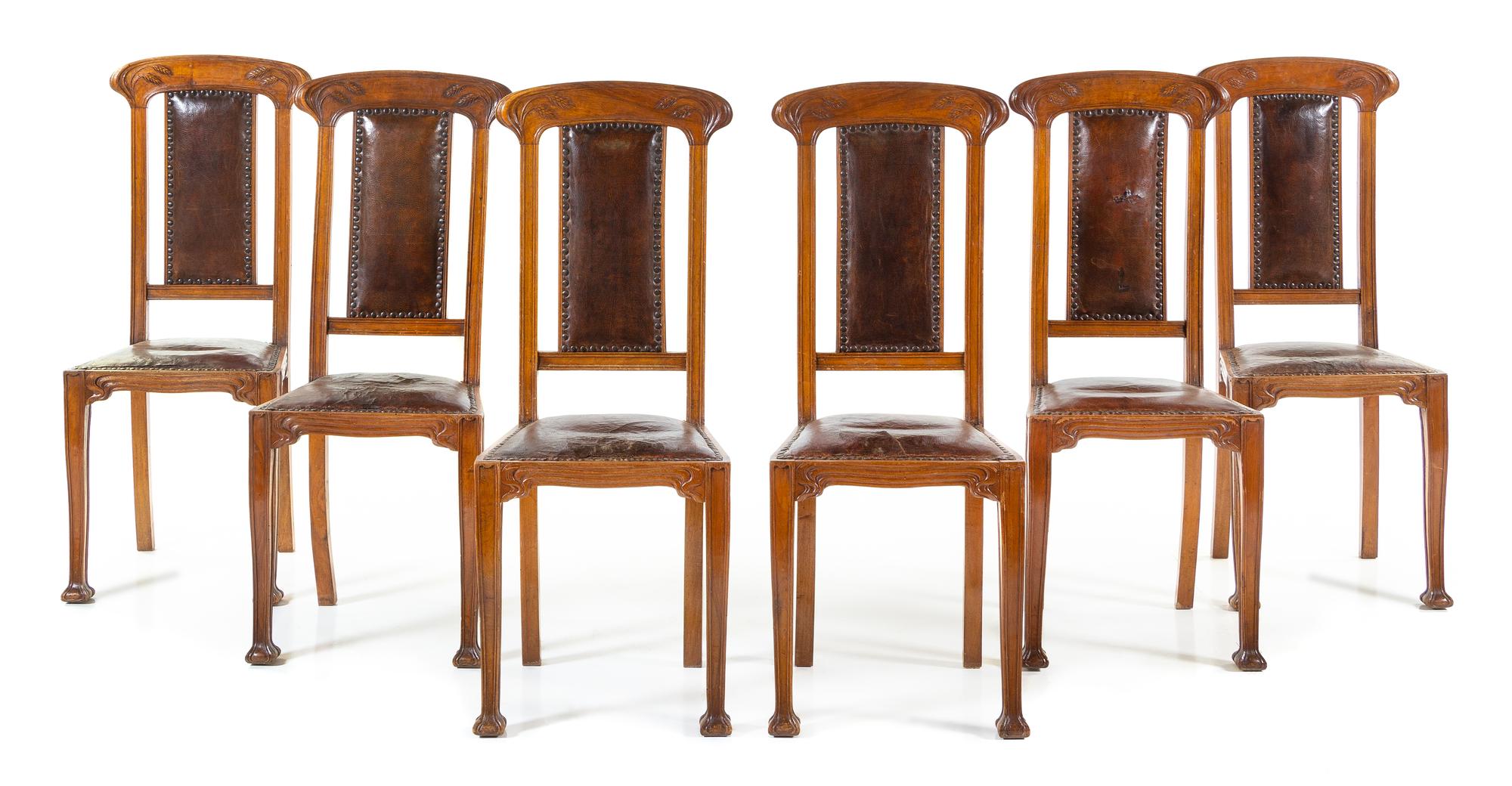 An Italian Art Nouveau Style Walnut Dining Suite Height of table 31 1/2 x width 47 1/2 (closed) x depth 40 1/4 inches. — 20TH CENTURY