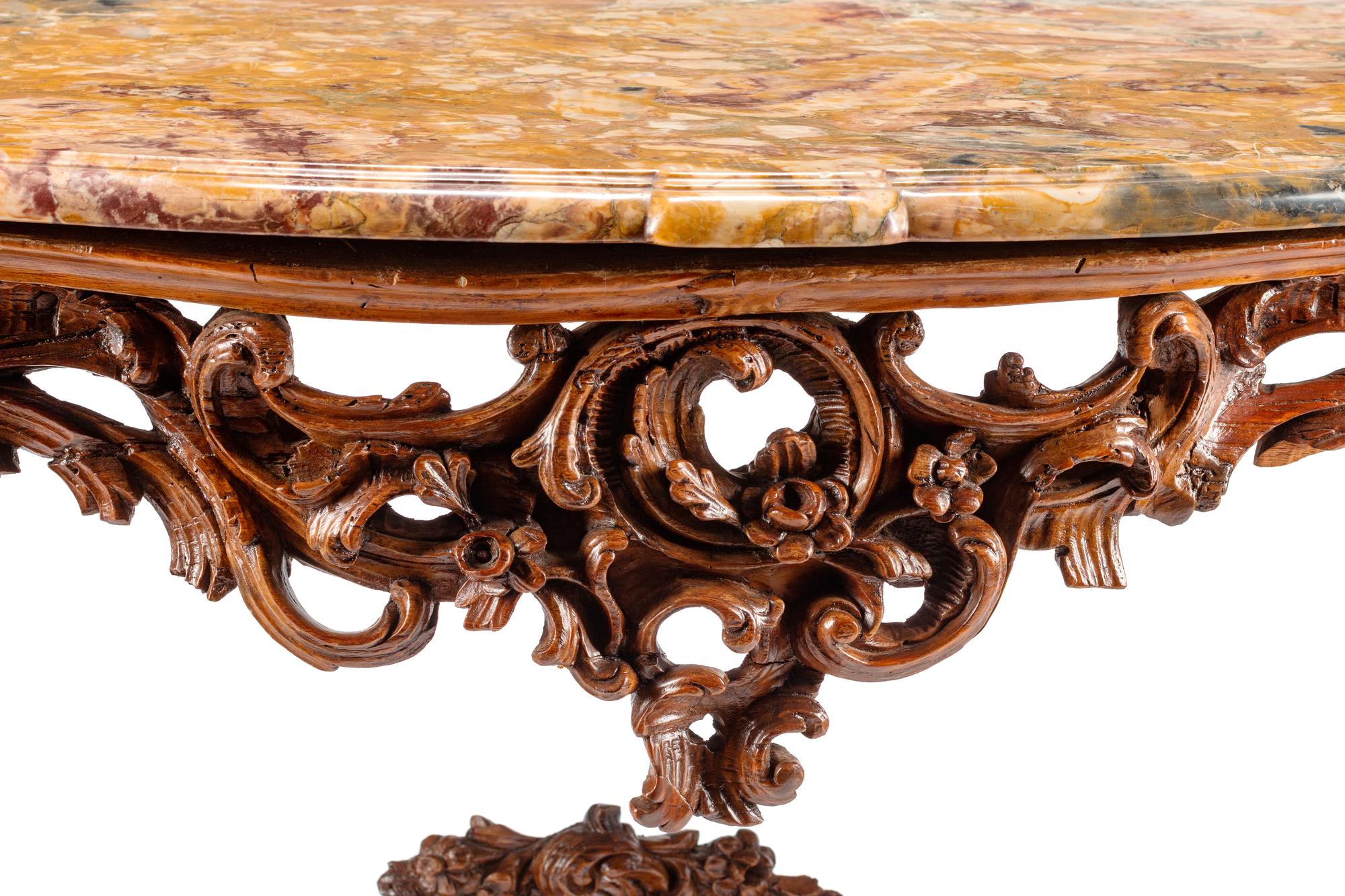 An Italian Rococo Carved Walnut Marble-Top Console Table