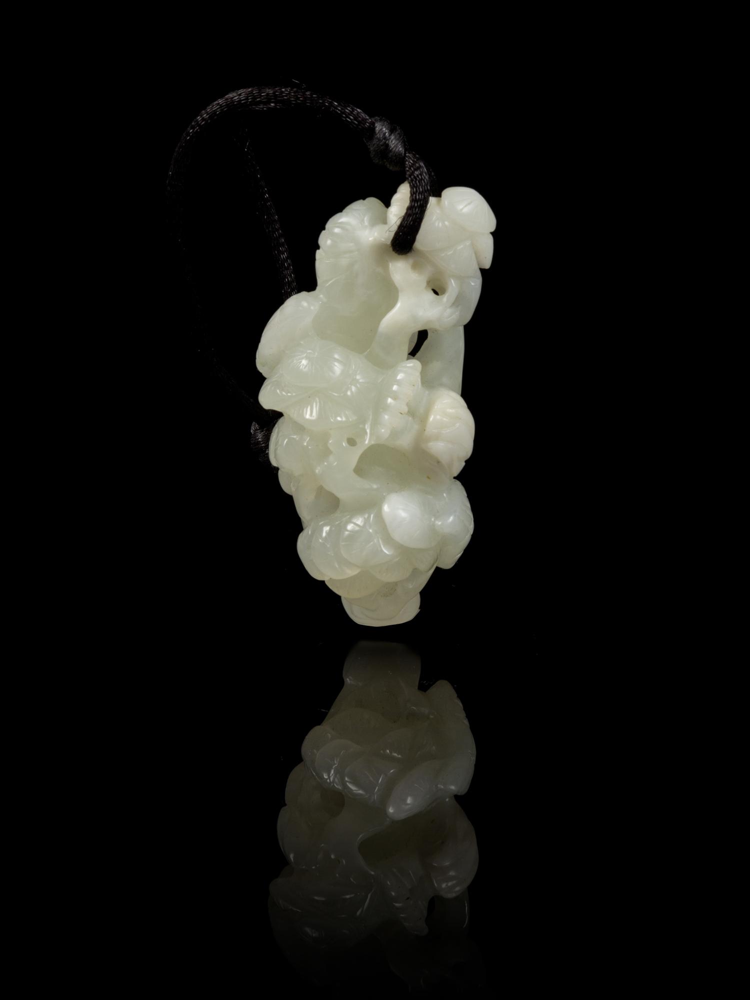 A Carved Jade Toggle Length 2 1/2 inches.