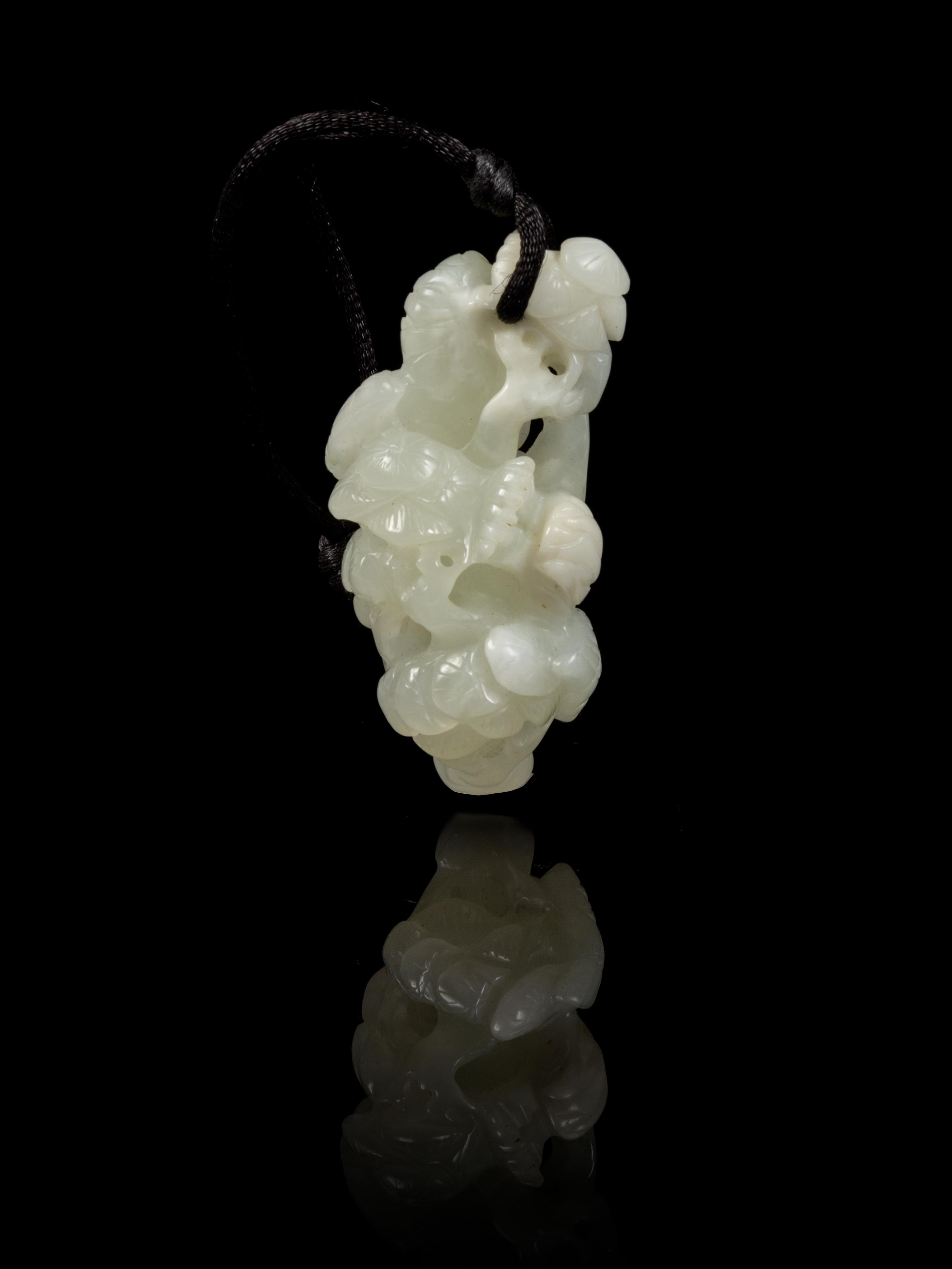 A Carved Jade Toggle Length 2 1/2 inches.
