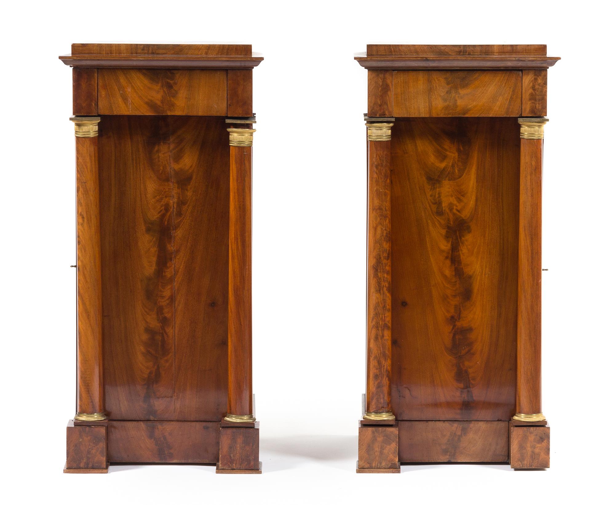 A Pair of Empire Mahogany Pedestal Cabinets Height 33 1/2 x width 16 x depth 15 1/2 inches. — 19TH CENTURY