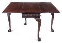 A George II Mahogany Drop-Leaf Table Height 28 x width 36 1/2 x depth 18 inches (closed). — PROBABLY IRISH, 18TH CENTURY