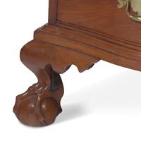 A Chippendale Figured and Shell-Carved Mahogany Reverse-Serpentine Chest of Drawers