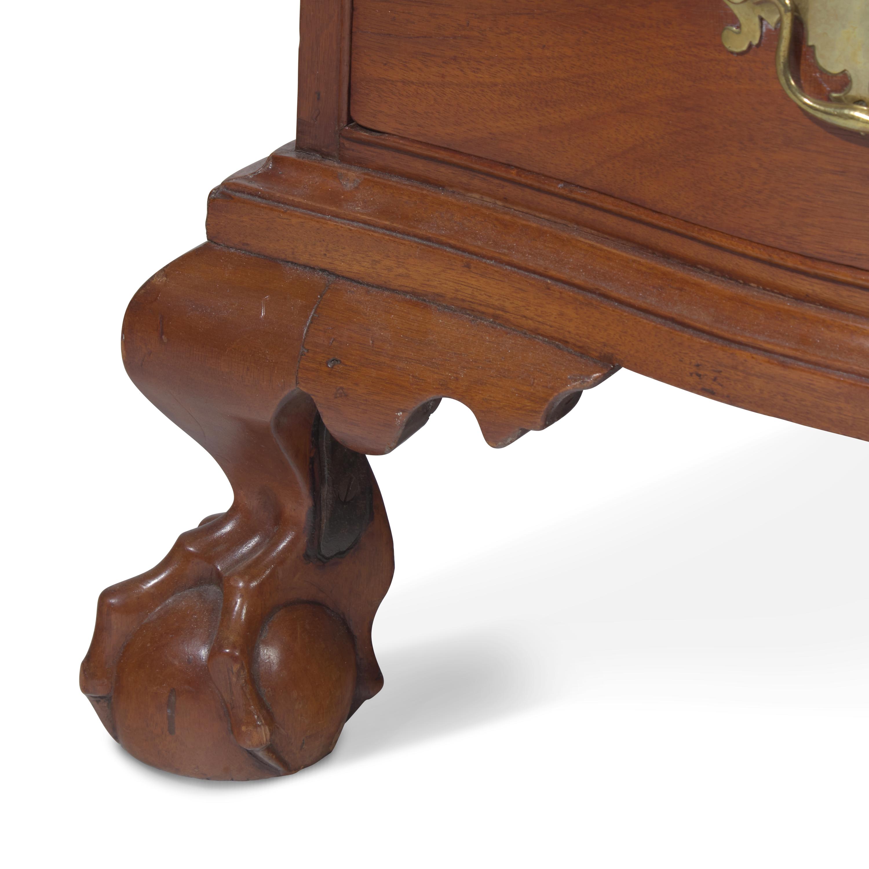A Chippendale Figured and Shell-Carved Mahogany Reverse-Serpentine Chest of Drawers