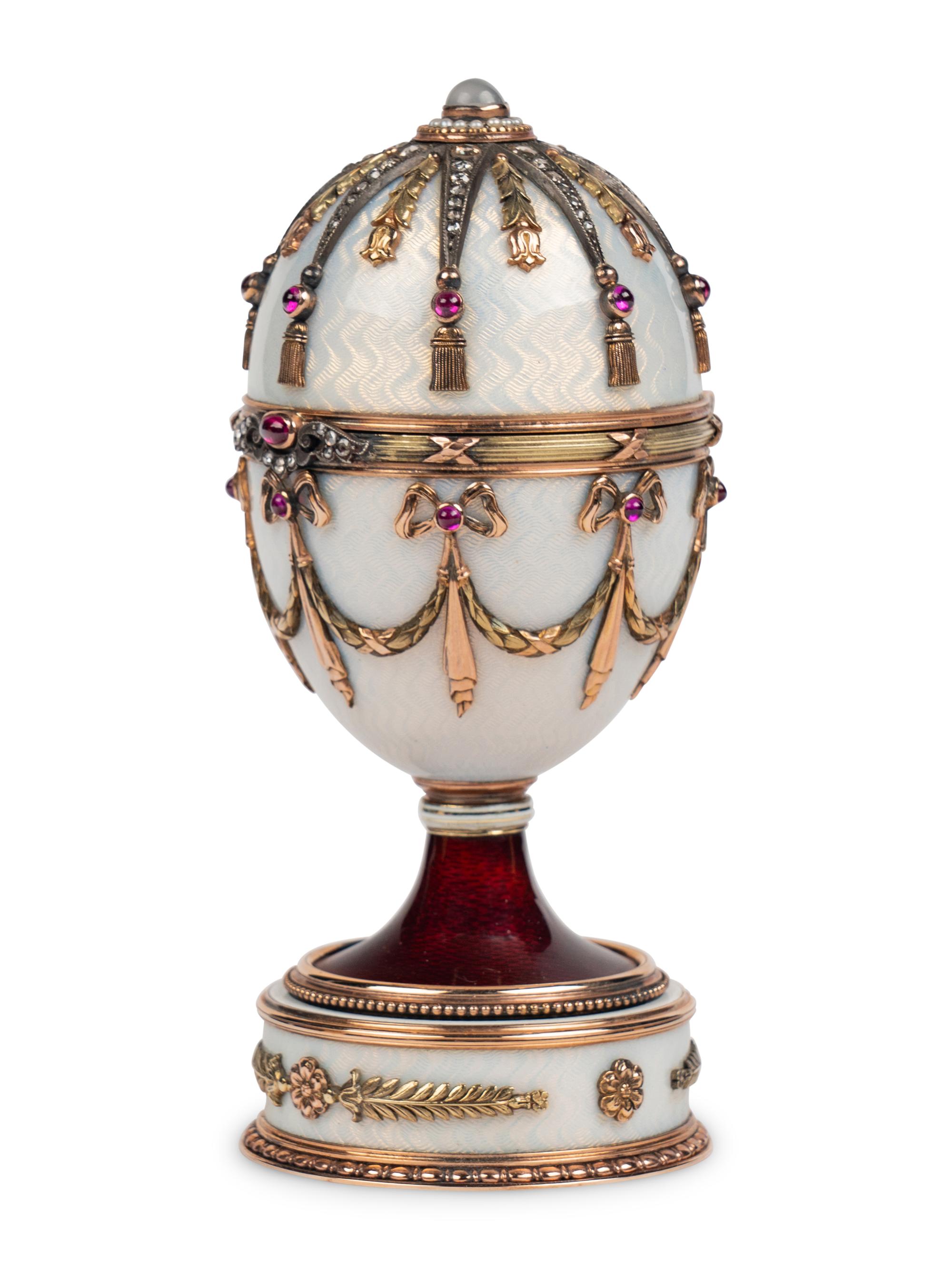 A 14 Karat Vari-Color Gold, Silver, Guilloché Enamel, Diamond, Pearl, and Cabochon Jewel-Mounted Surprise Egg