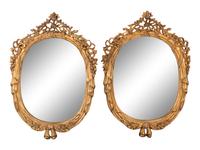 A Pair of Louis XV Style Giltwood Oval Mirrors