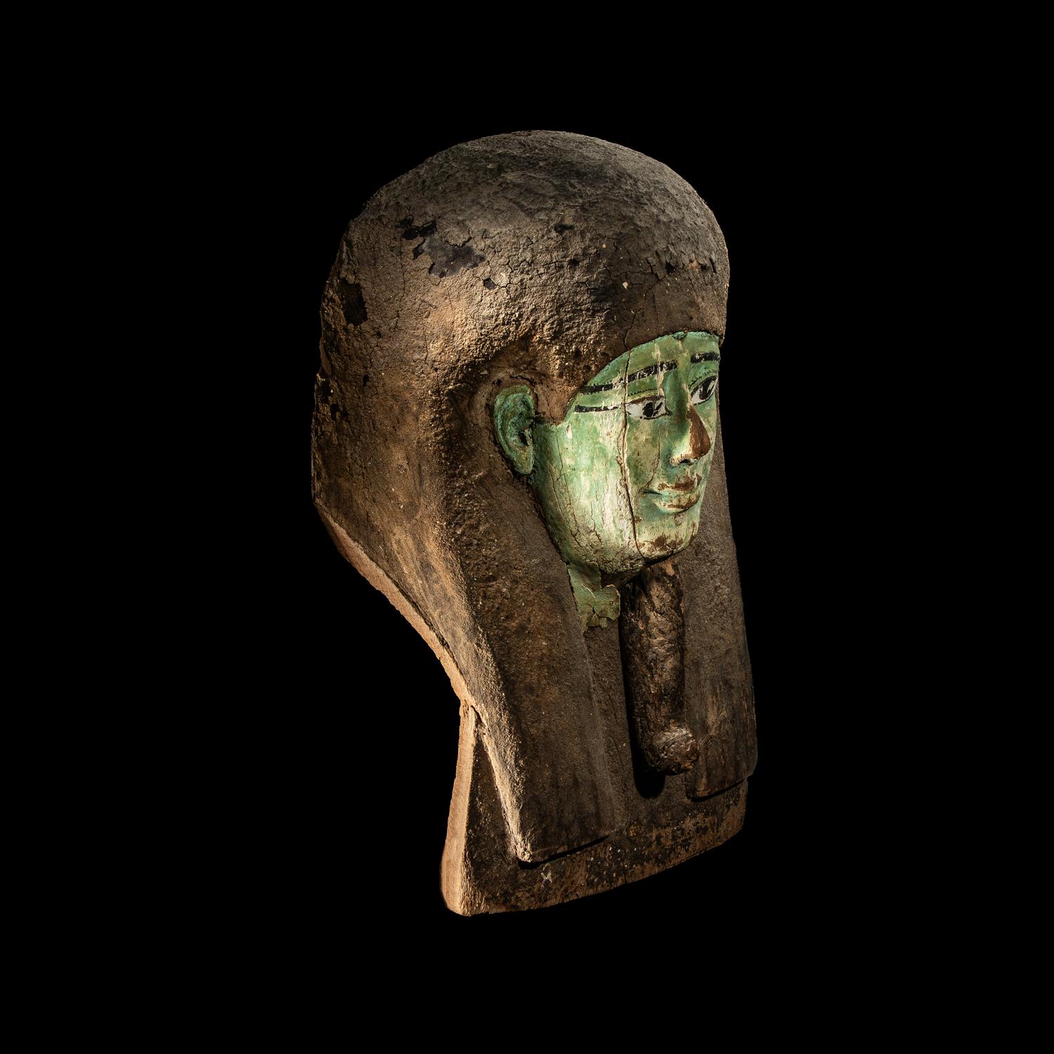 An Egyptian Painted Wood Sarcophagus Head