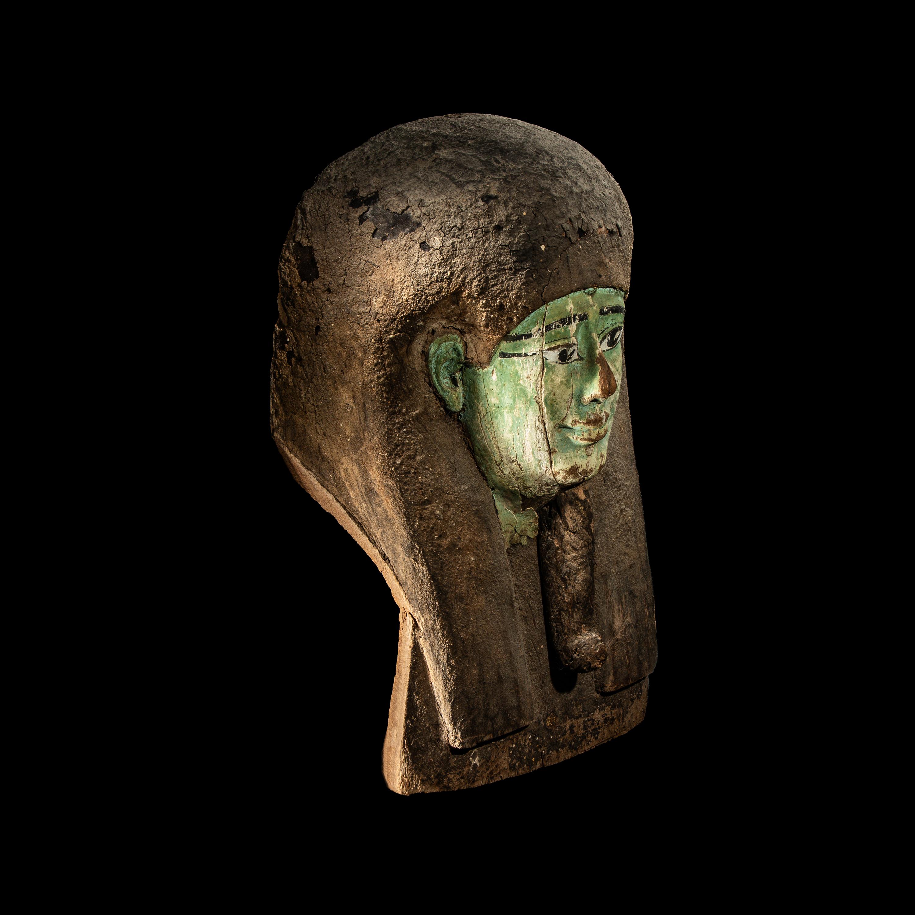 An Egyptian Painted Wood Sarcophagus Head