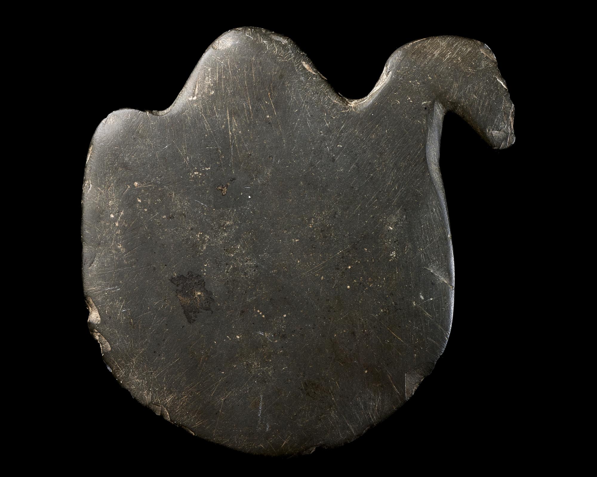 An Egyptian Greywacke Cosmetic Palette in the Form of a Bird