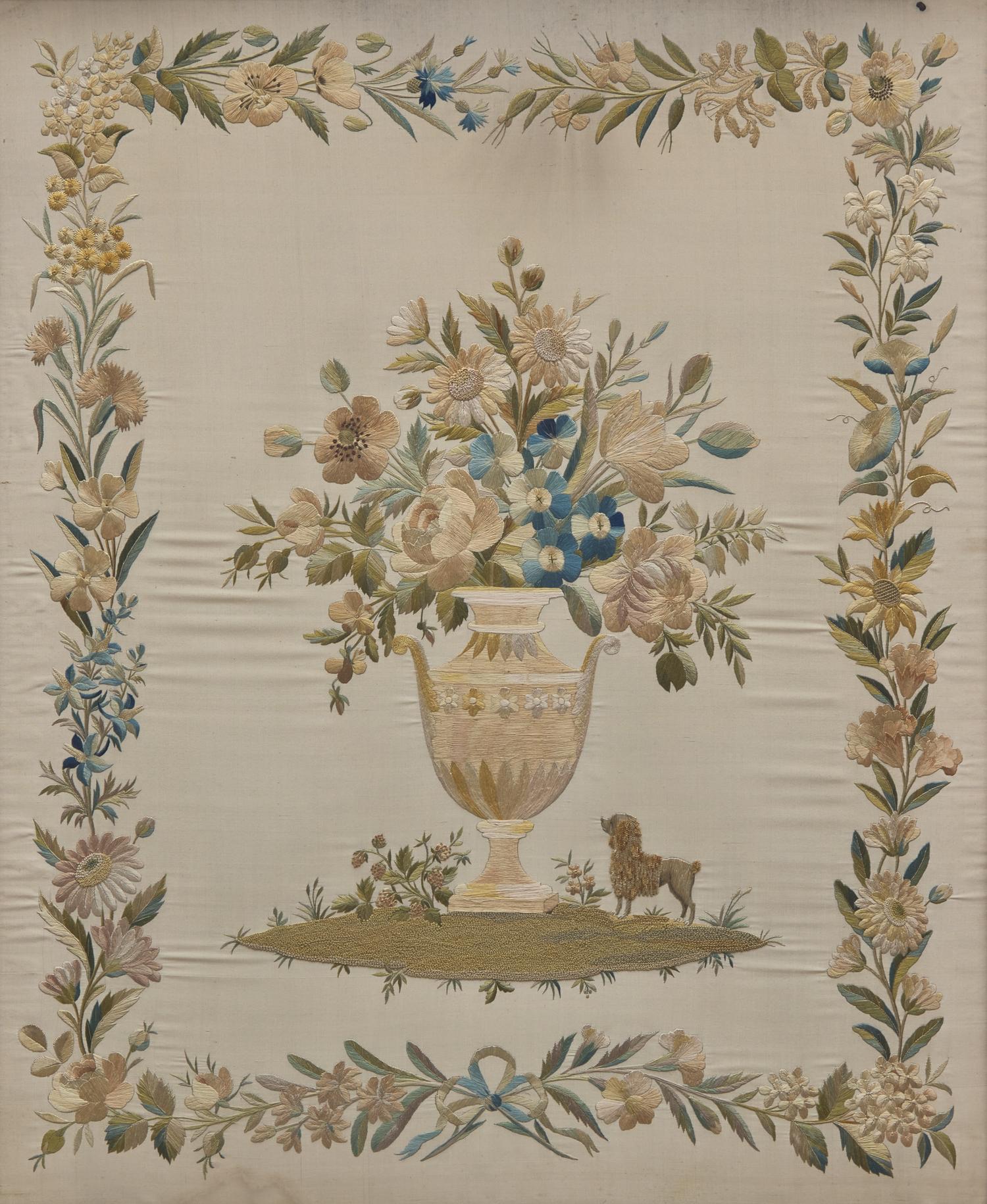An English Regency Embroidered Silkwork Picture of a Floral Urn with Poodle