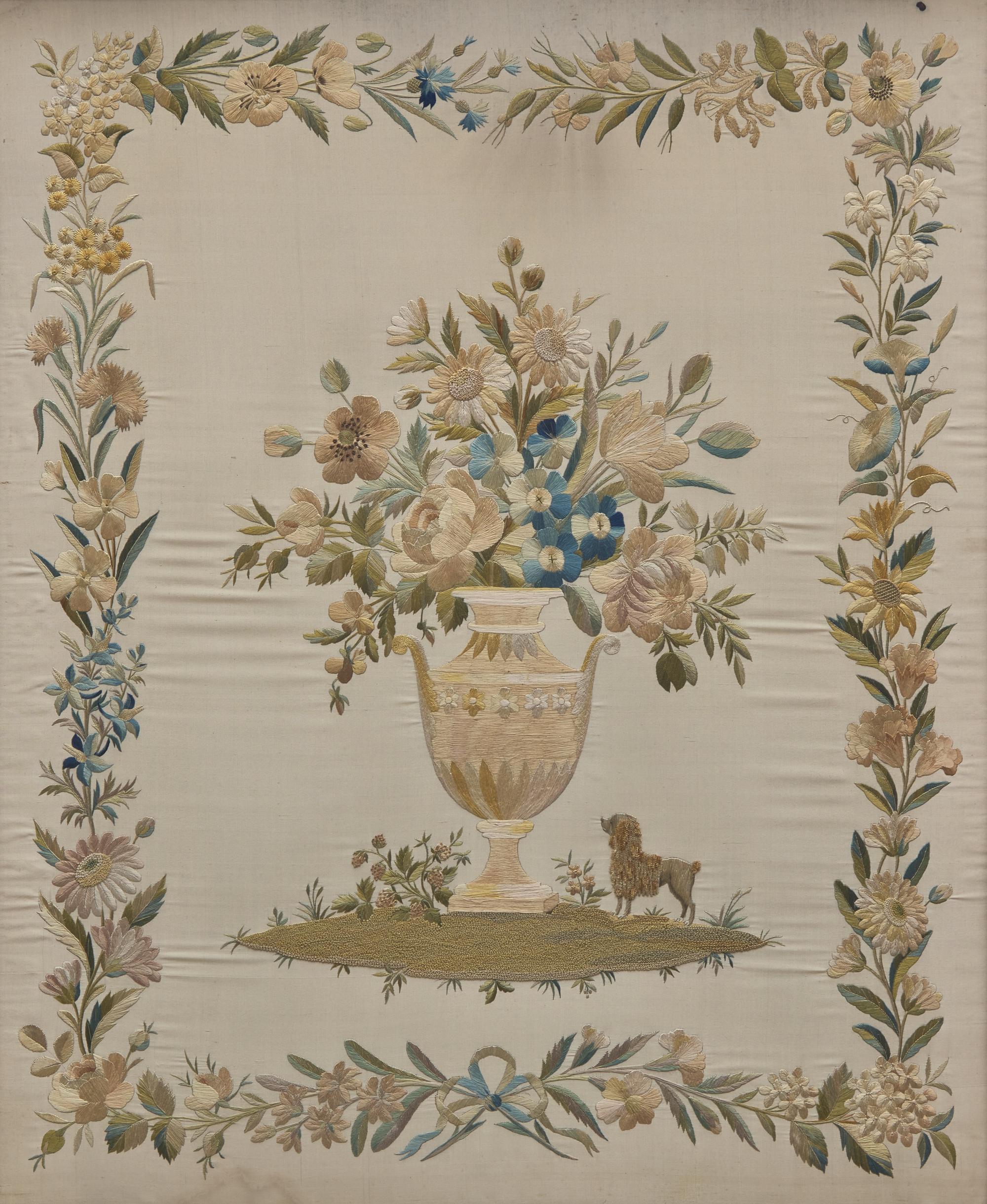 An English Regency Embroidered Silkwork Picture of a Floral Urn with Poodle