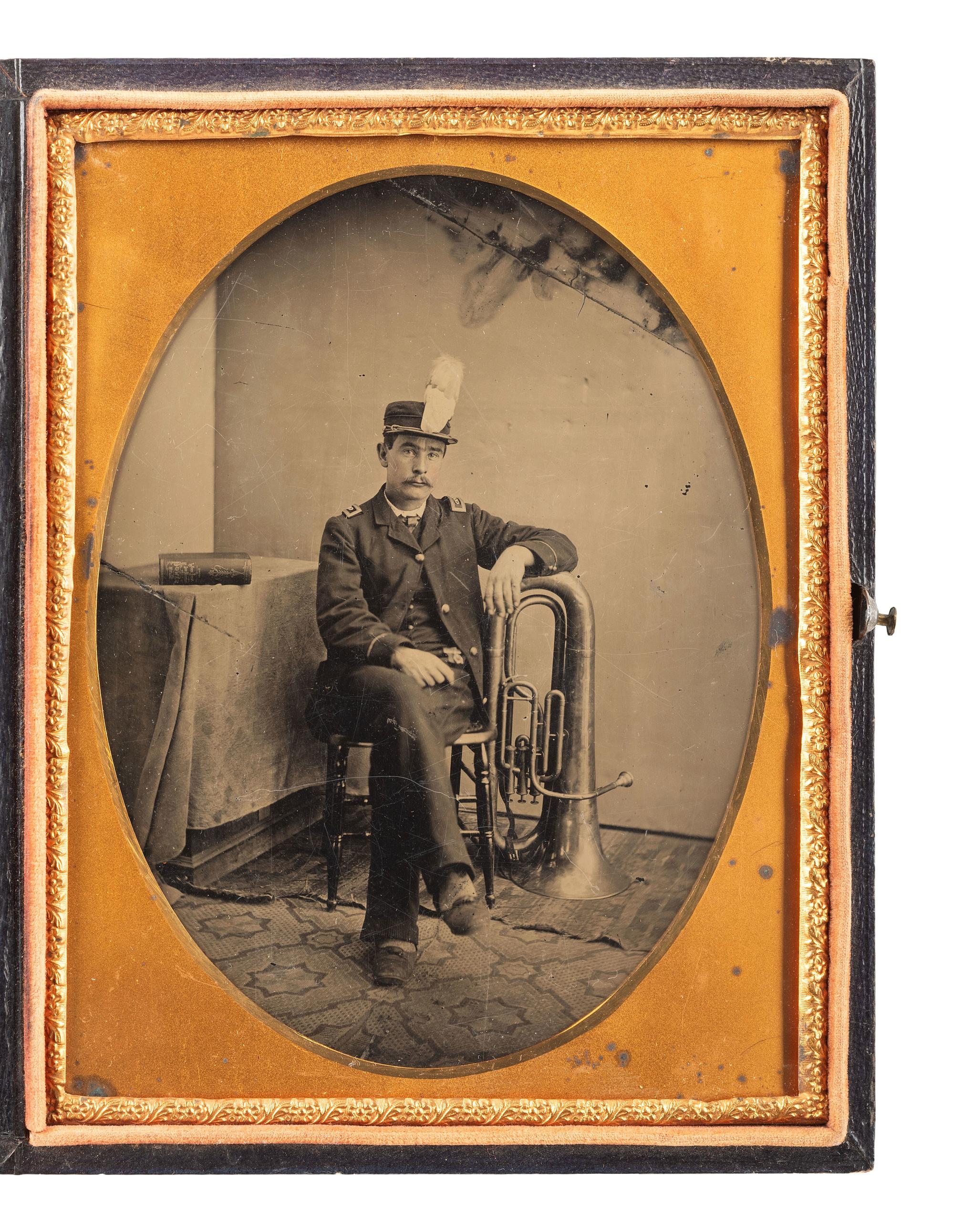 [EARLY PHOTOGRAPHY]. Half plate tintype of a band member with his sax horn. Ca 1890.