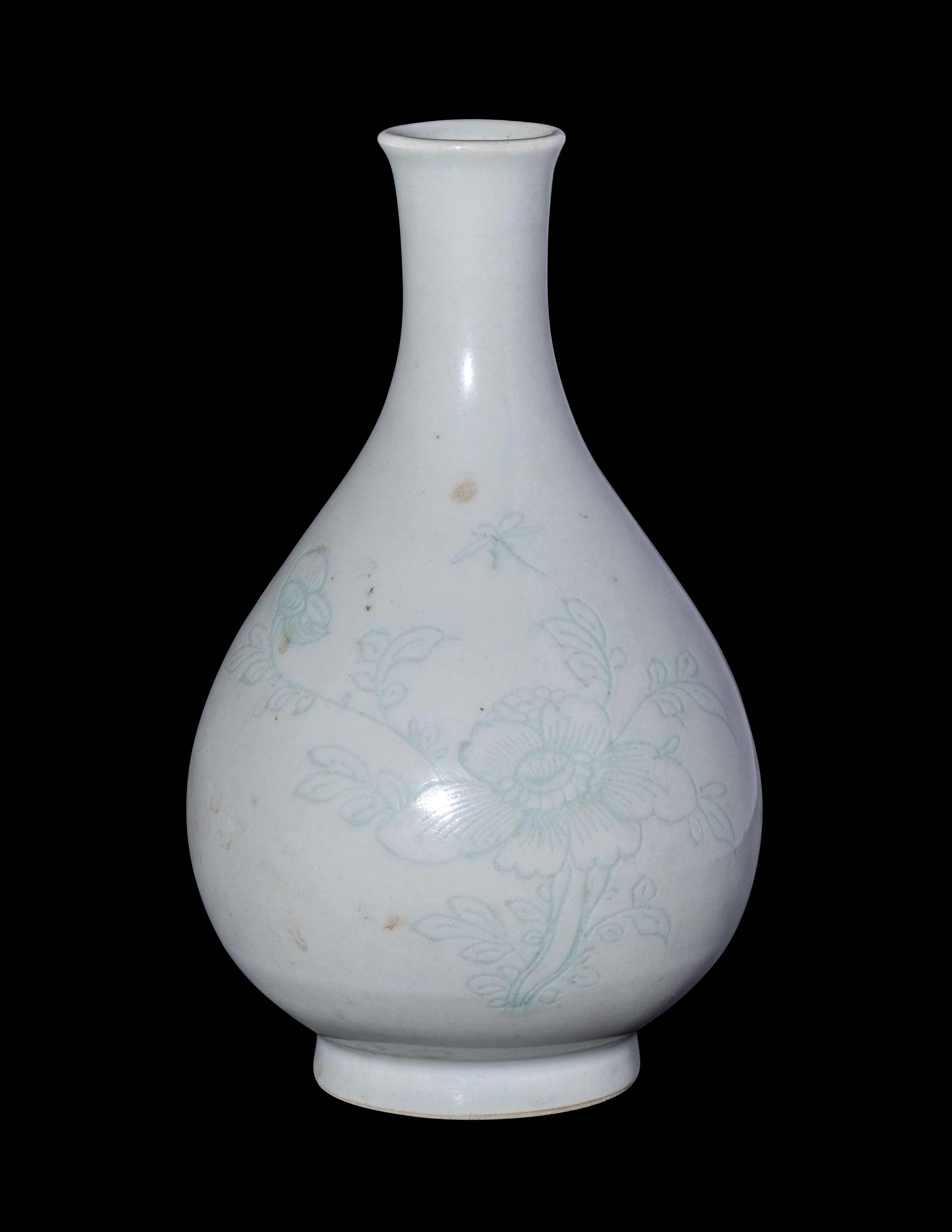 A Chinese Carved White Glazed Porcelain Bottle Vase | Freeman's