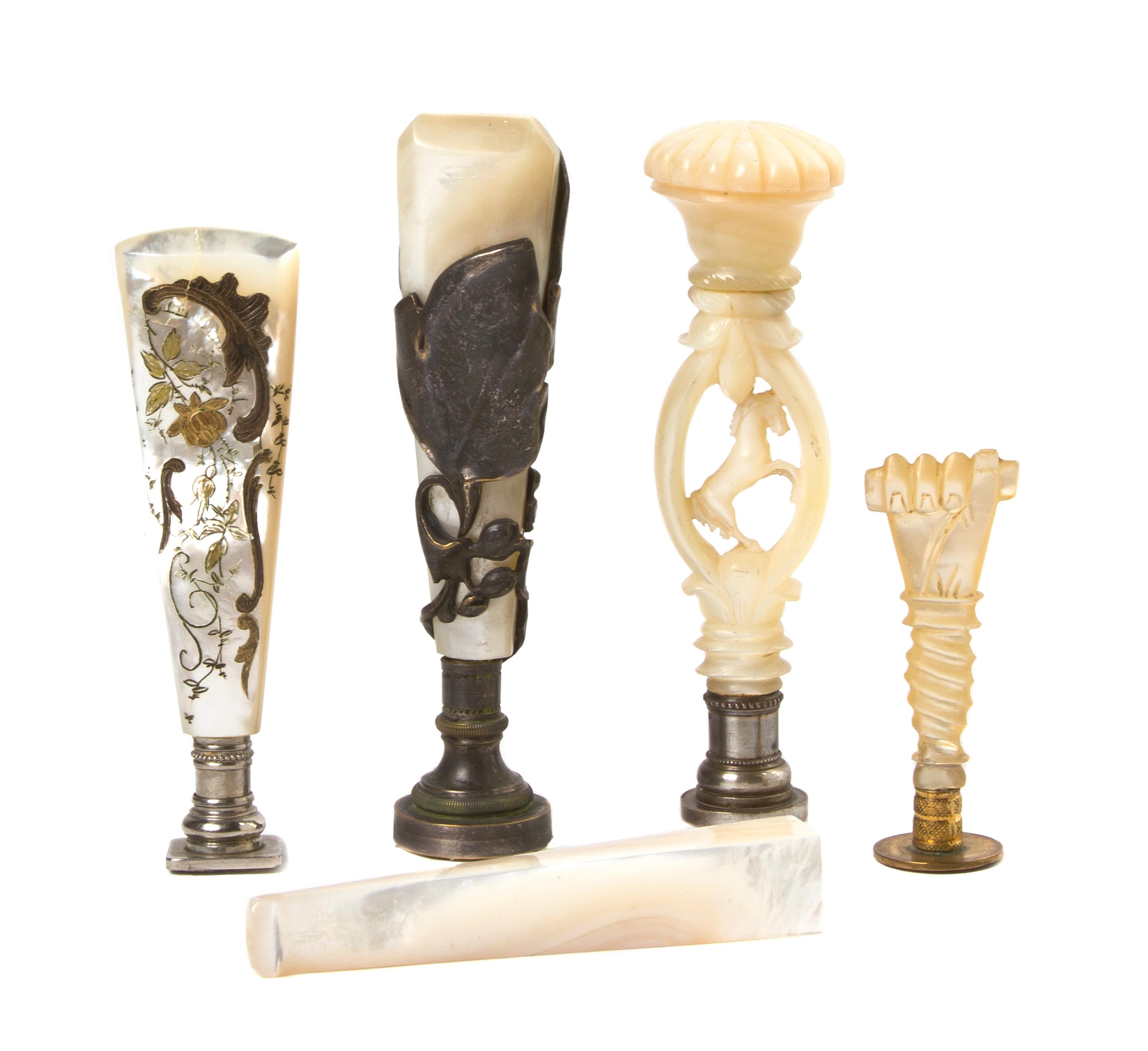A Collection of Mother-of-Pearl Mounted Seals, Length of longest 3 3/4 inches.
