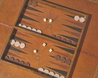 An impressive pair of Regency rosewood and parcel-gilt and ebonized games tables, circa 1820