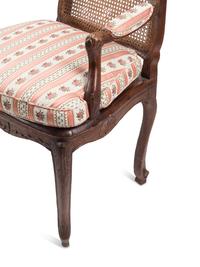 A Pair of Louis XV Provincial Walnut Caned Fauteuils