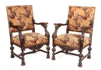 A Pair of Victorian Carved Oak Open Armchairs Height 41 1/4 inches.