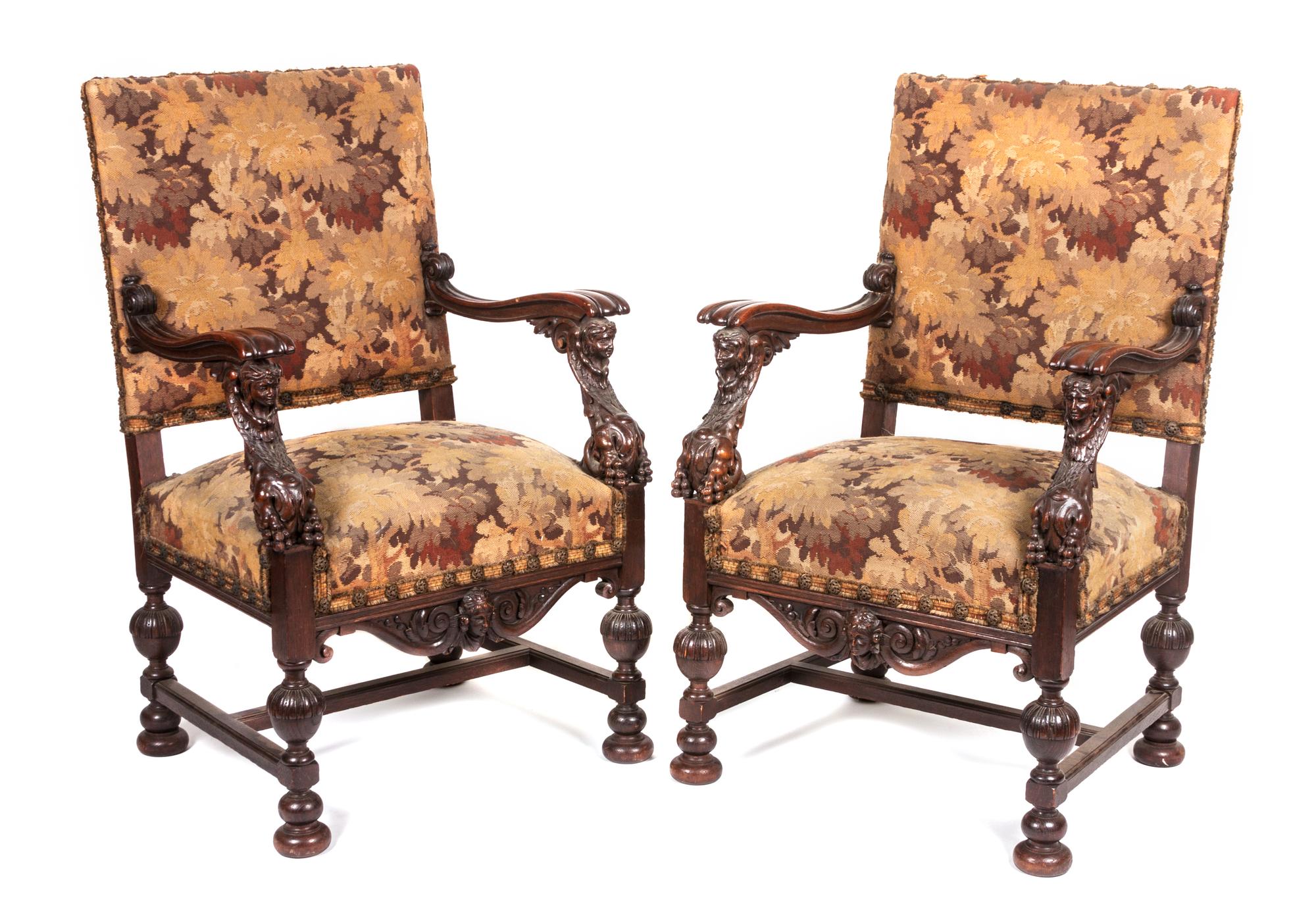 A Pair of Victorian Carved Oak Open Armchairs Height 41 1/4 inches.