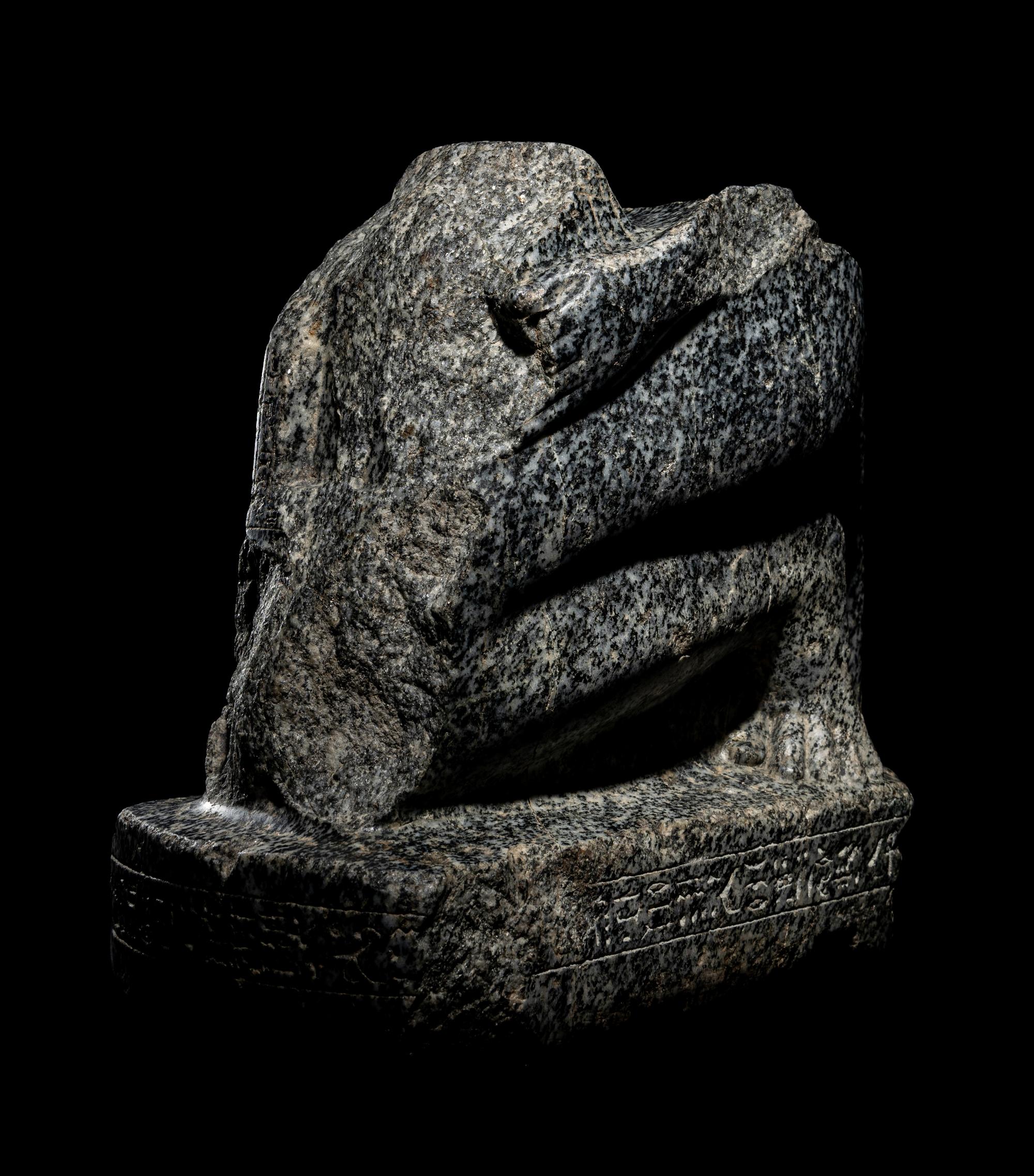 An Egyptian Gneiss Fragment of a Kneeling Figure