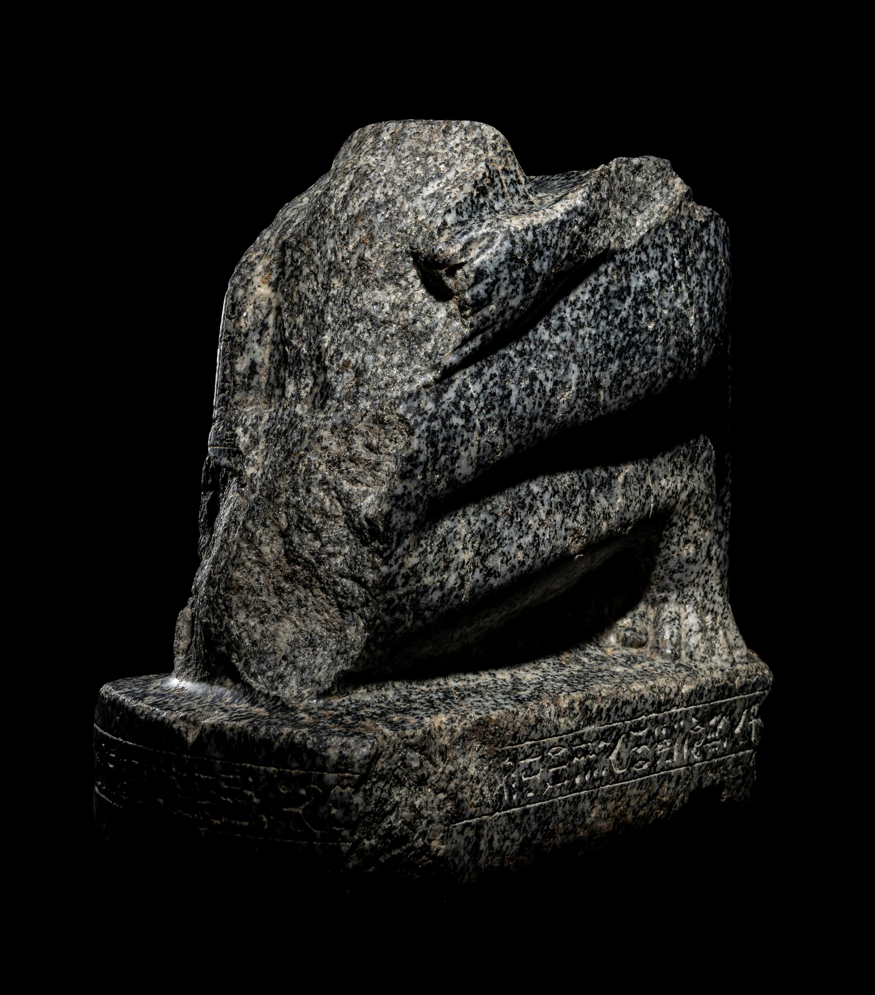 An Egyptian Gneiss Fragment of a Kneeling Figure