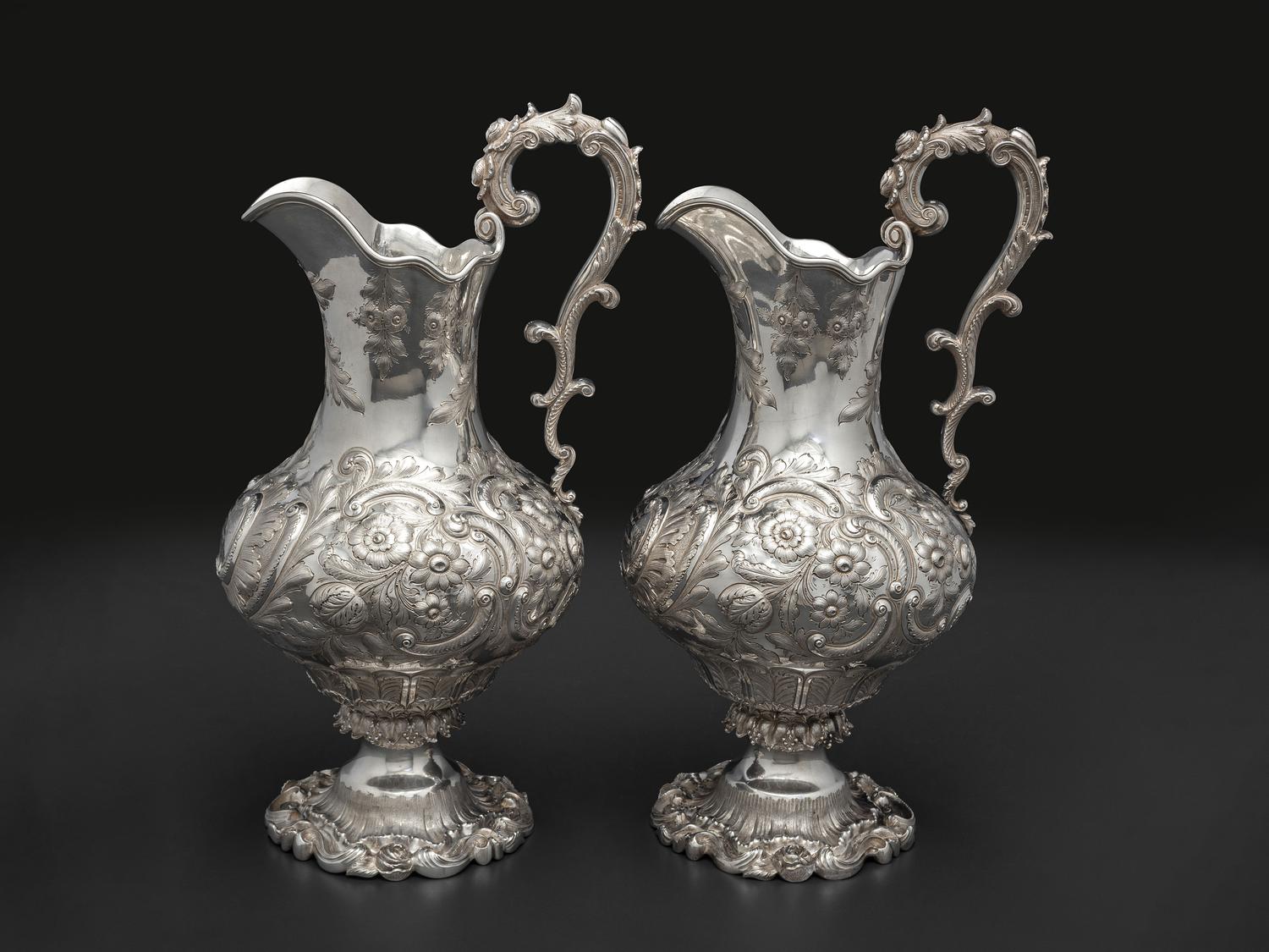 A Pair of American Repousse Silver Presentation Pitchers