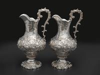 A Pair of American Repousse Silver Presentation Pitchers