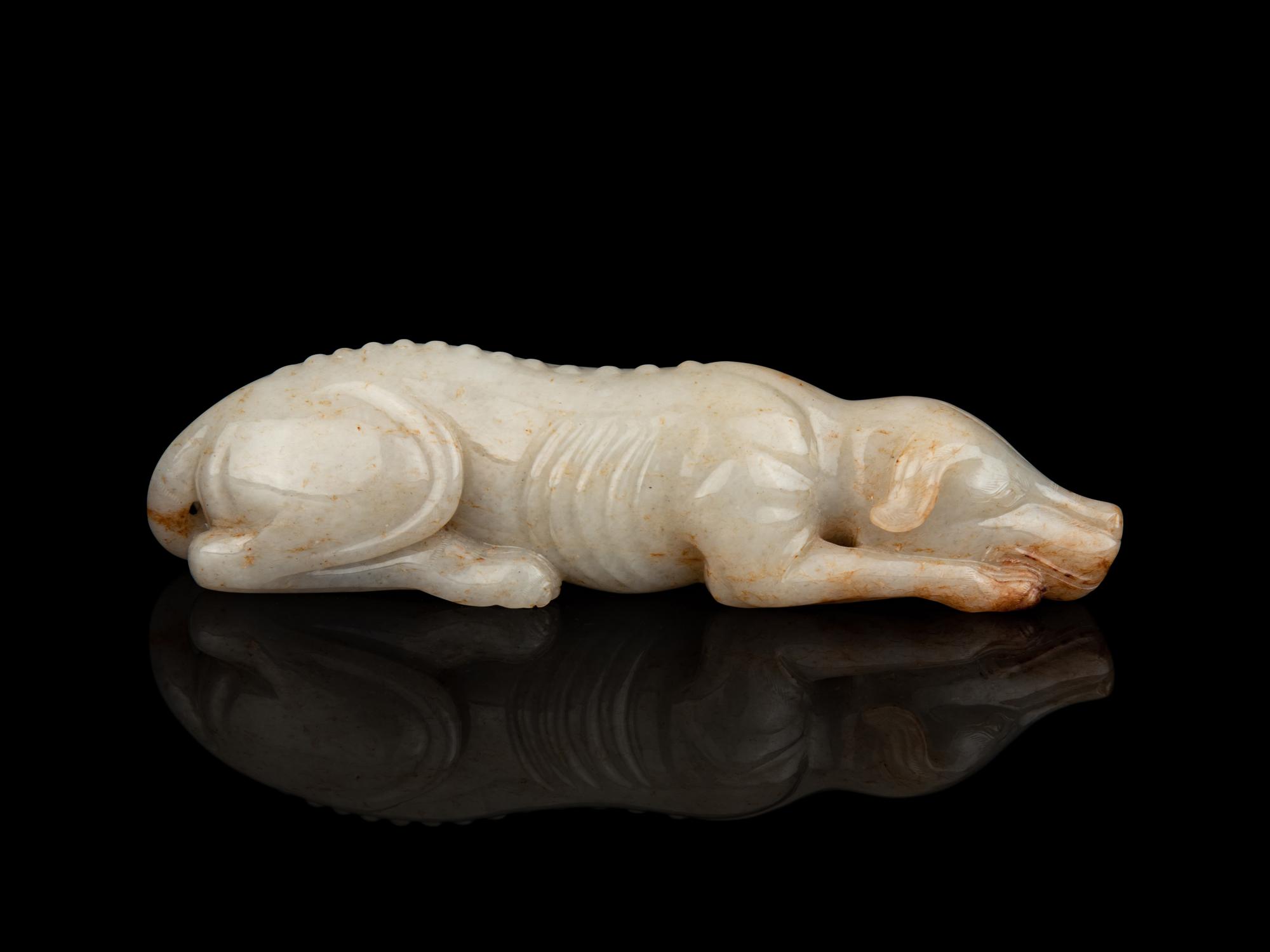 A White and Russet Jade Figure of a Recumbent Dog