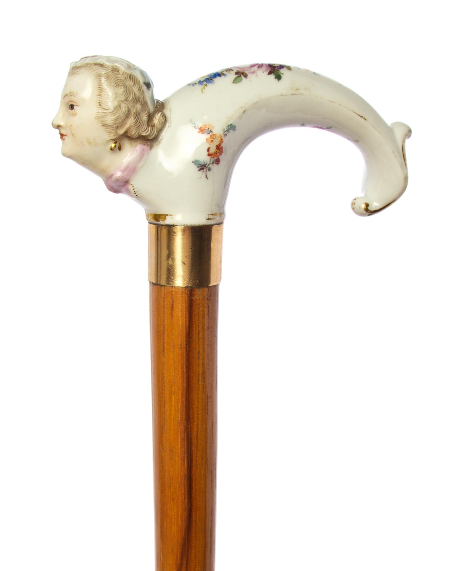 A German Meissen Style Porcelain Handled Cane, Length of handle 4 1/4 x length overall 33 3/4 inches.