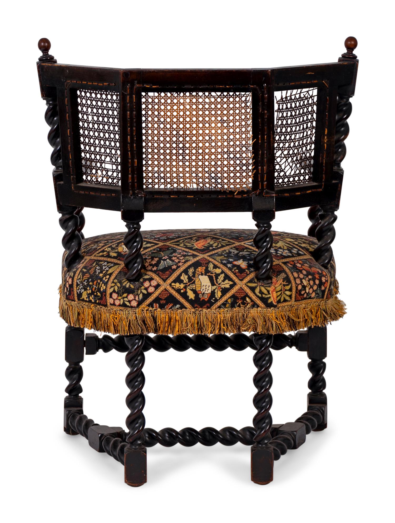 A Jacobean Style Carved Oak Cane Back Armchair — 19TH/20TH CENTURY
