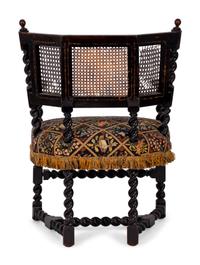 A Jacobean Style Carved Oak Cane Back Armchair — 19TH/20TH CENTURY