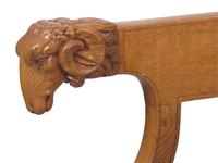 A Charles X Amaranth-Inlaid Golden Oak and Rams' Head Fauteuil