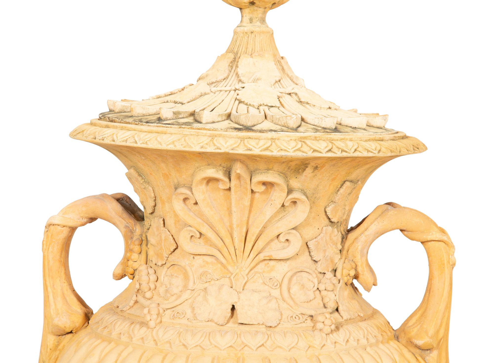 A Pair of Cast Terra Cotta Covered Garden Urns on Painted Wood Pedestals