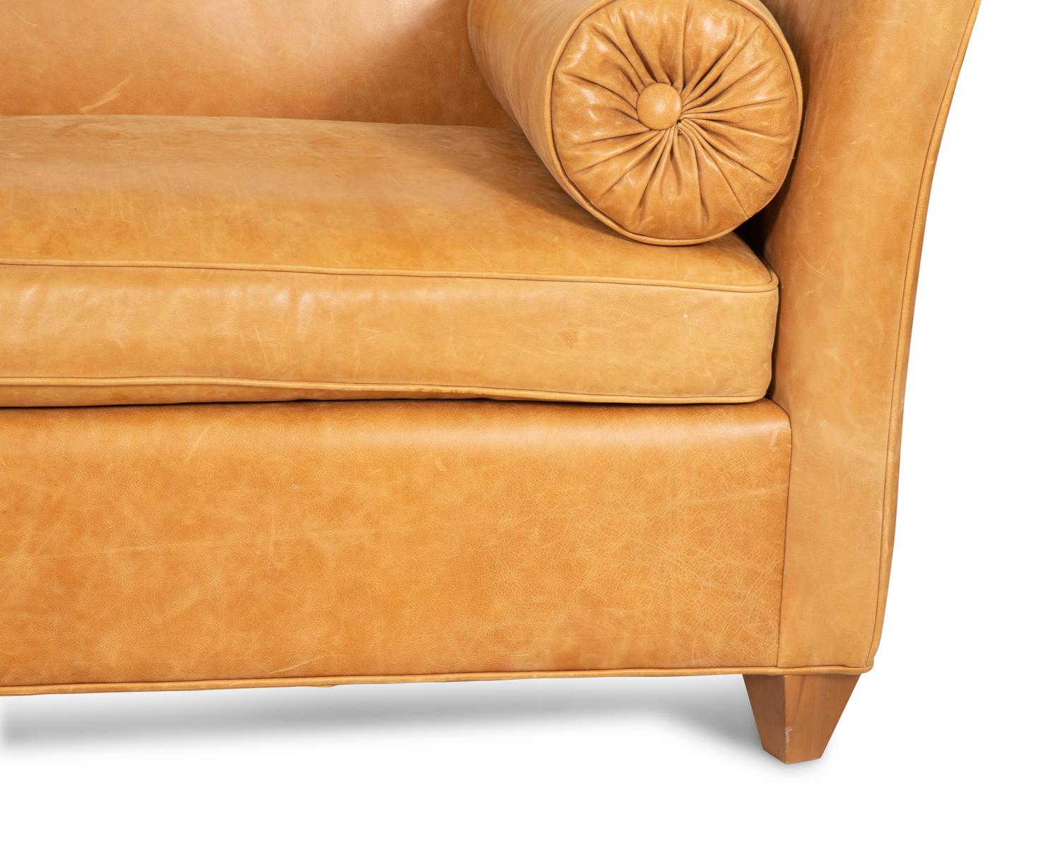 A Contemporary Leather Sofa with Two Bolster Pillows