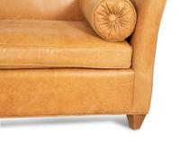 A Contemporary Leather Sofa with Two Bolster Pillows