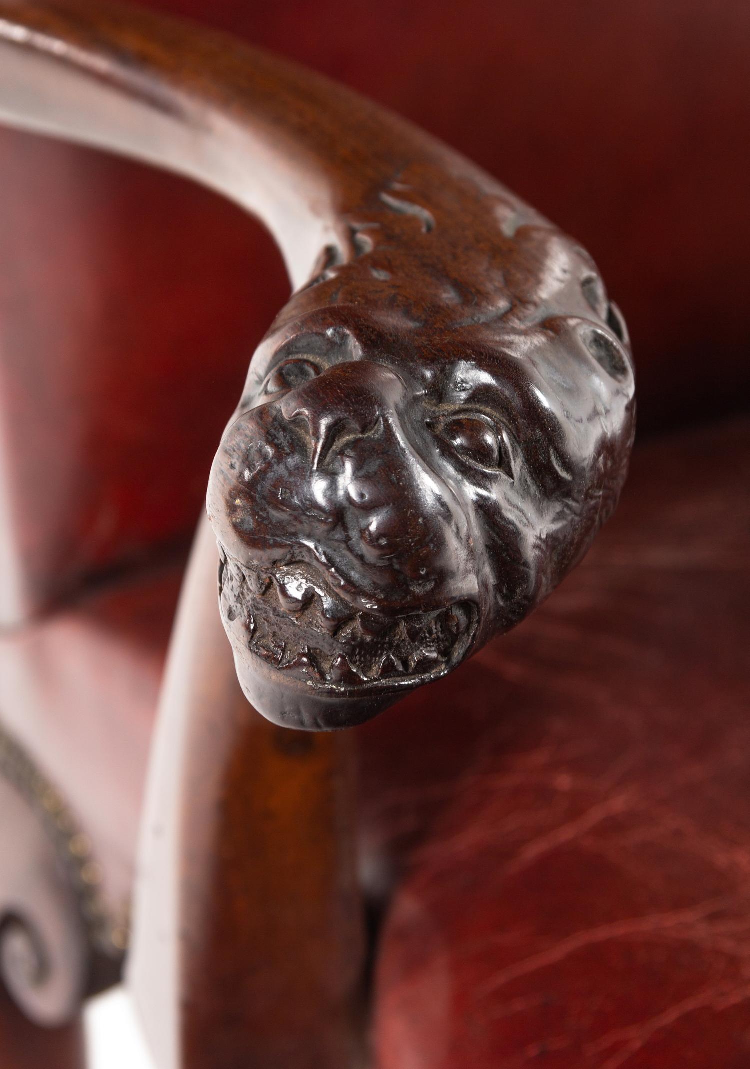 A George II Leather-Upholstered Carved Mahogany Library Chair