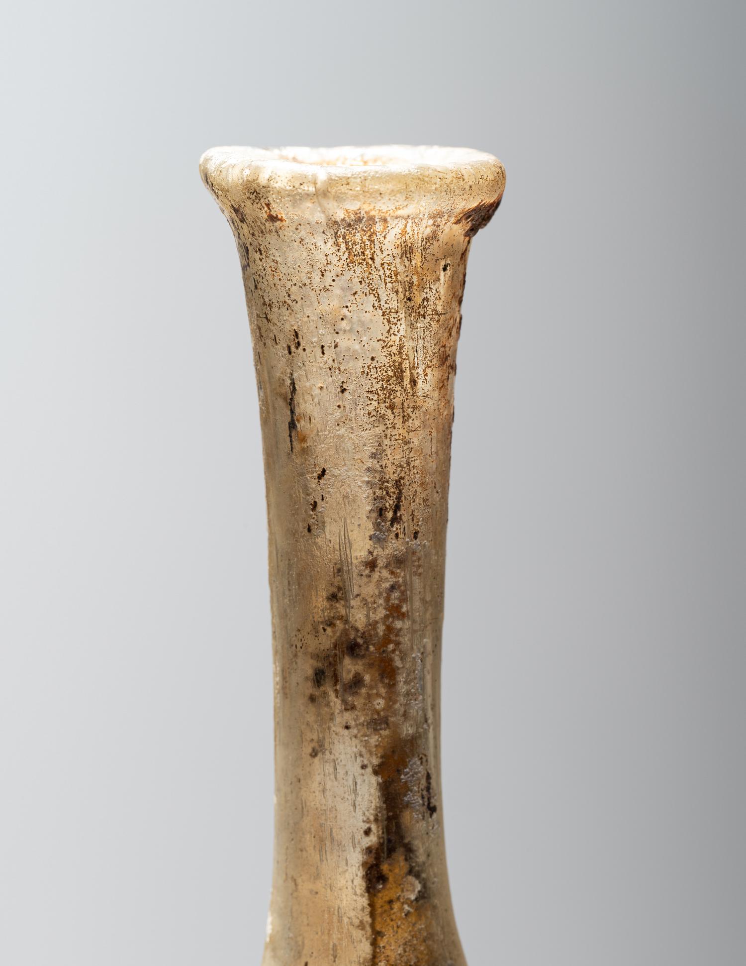 A Roman Pale Yellow Glass Unguentarium