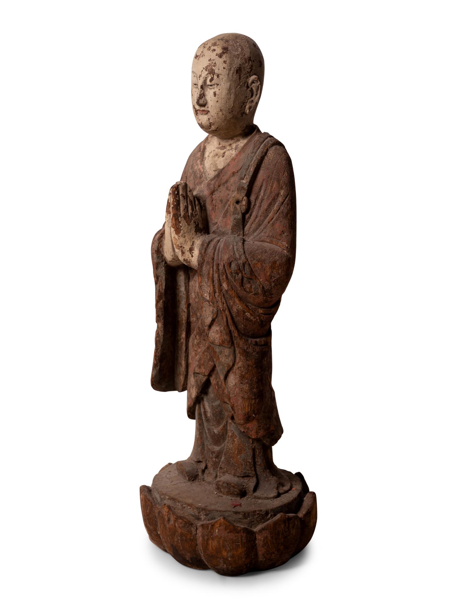 A Chinese Carved and Polychrome Decorated Wood Figure in Prayer
