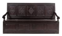 A Jacobean Style Oak Settle Height 41 3/8 x width 72 1/2 x depth 22 5/8 inches.