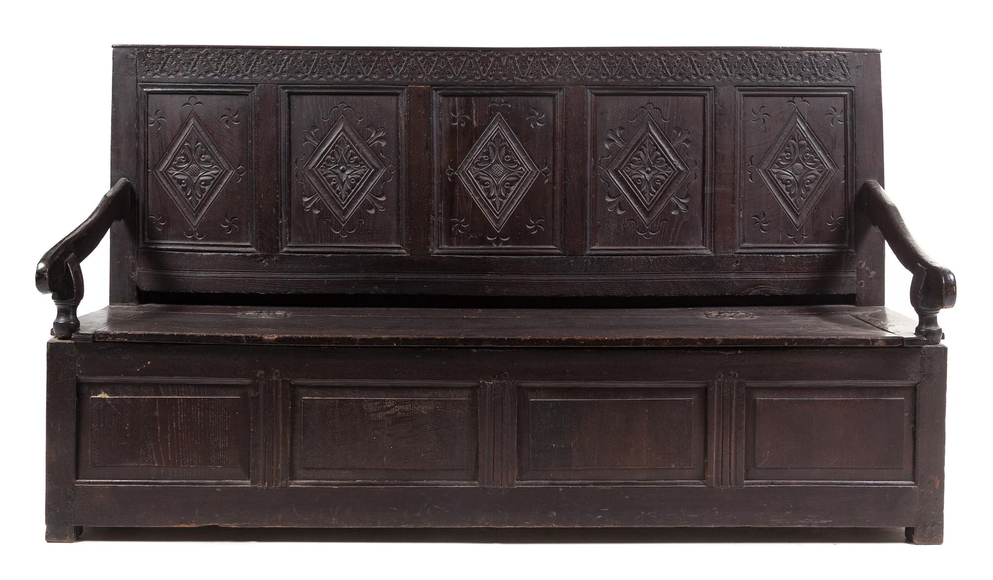 A Jacobean Style Oak Settle Height 41 3/8 x width 72 1/2 x depth 22 5/8 inches.
