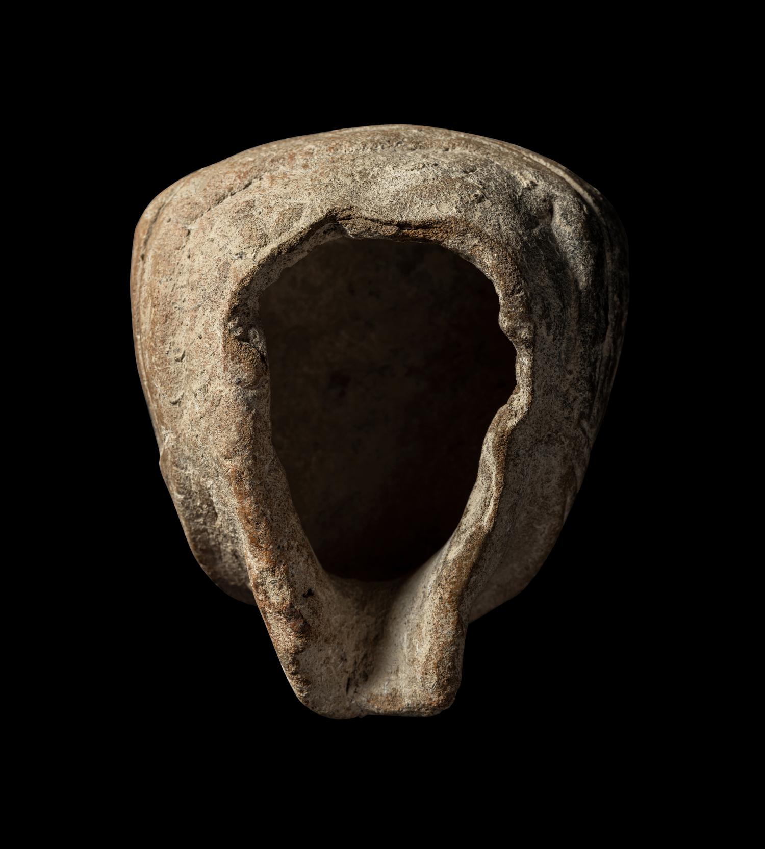 A Veracruz Terracotta Head Wearing a Helmet with an Incised Glyph