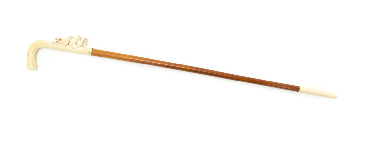 A Continental Relief Carved Ivory Cane, Height of handle 7 1/4 x length overall 34 1/8 inches.