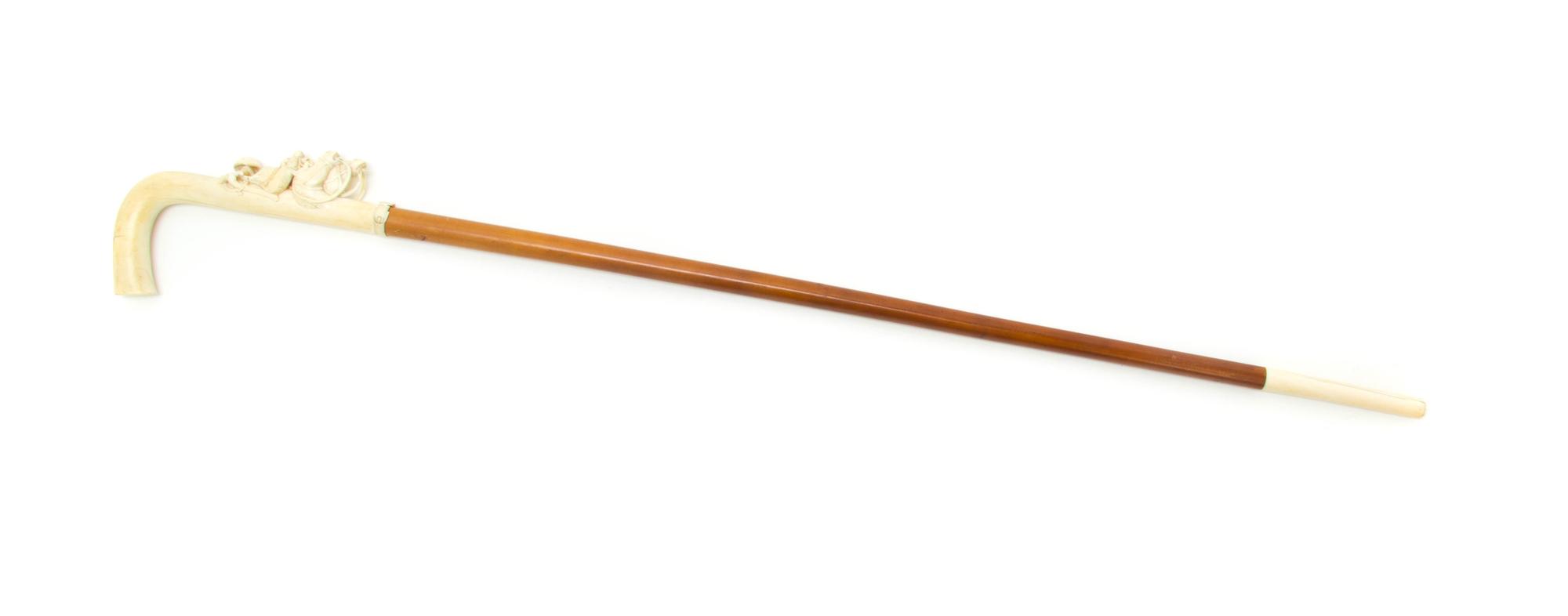 A Continental Relief Carved Ivory Cane, Height of handle 7 1/4 x length overall 34 1/8 inches.