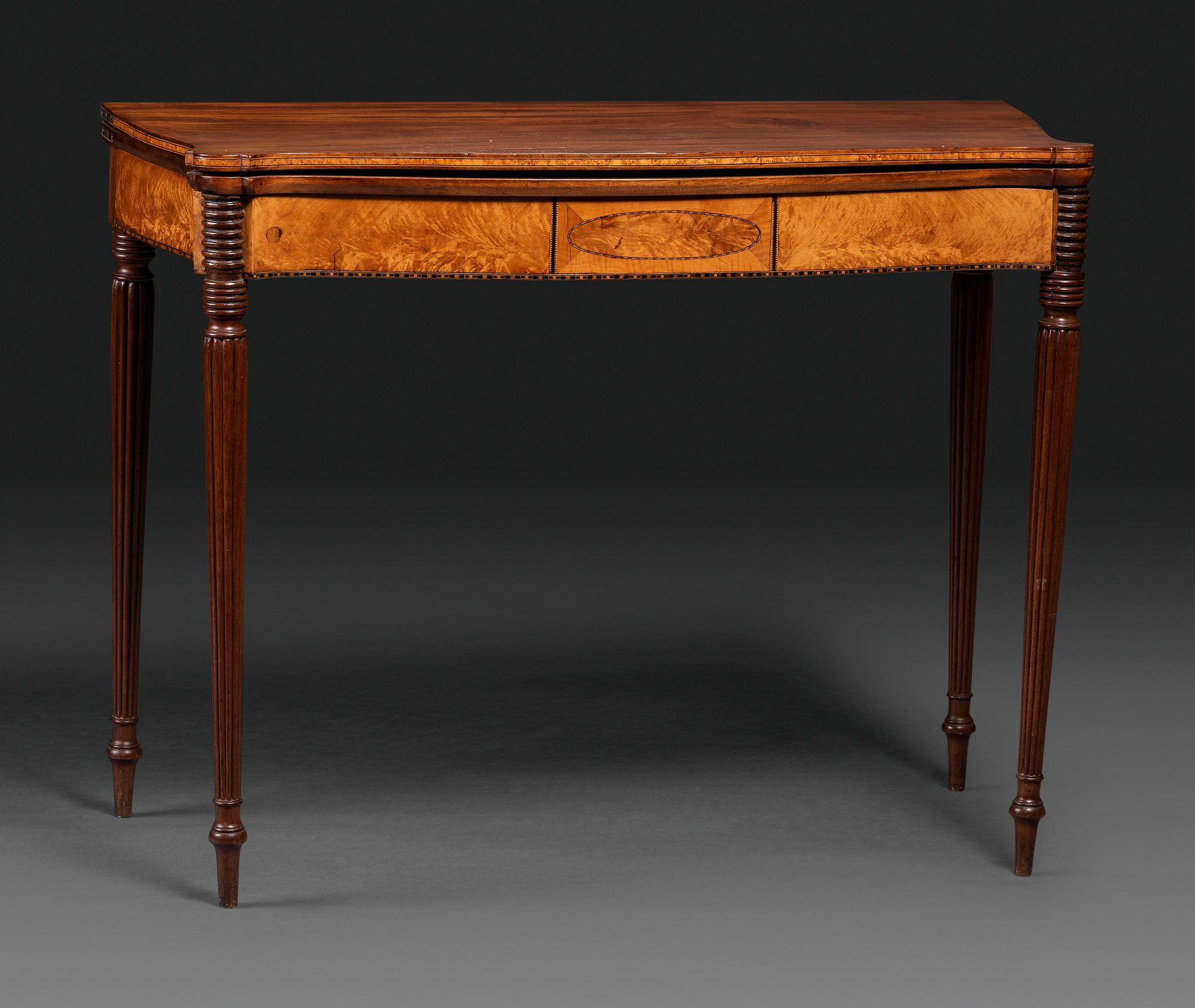 A Federal Birch Veneered and Inlaid Mahogany Serpentine-Top Games Table