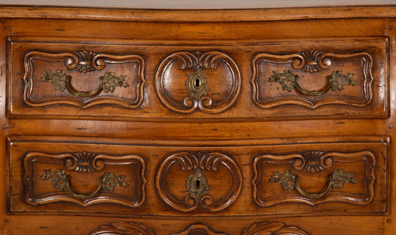 A Louis XV Provincial Style Carved Walnut Commode