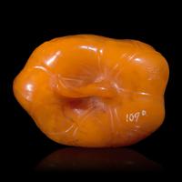 A Chinese 'Beeswax' Amber Lotus Pod and Leaf Pendant — 蜜蠟雕荷葉蓮蓬墜