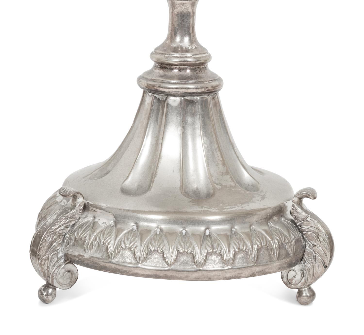 A Set of Four Continental Silvered Metal Candlesticks
