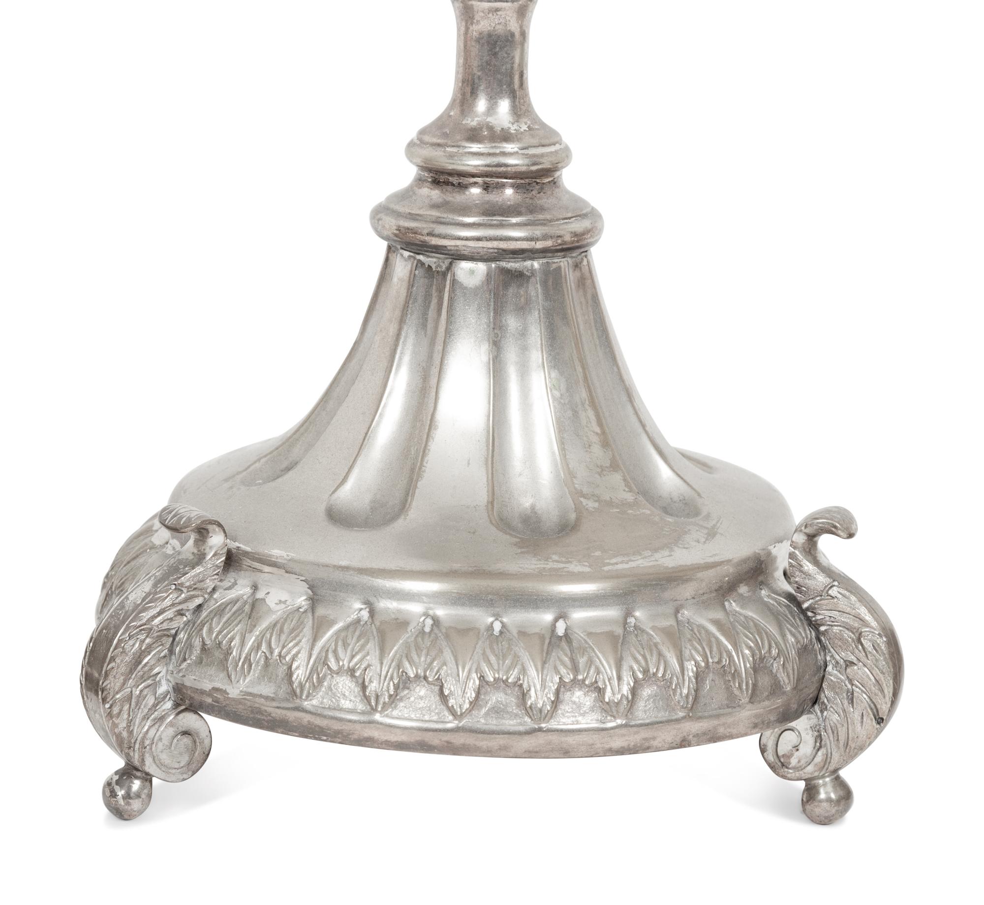 A Set of Four Continental Silvered Metal Candlesticks